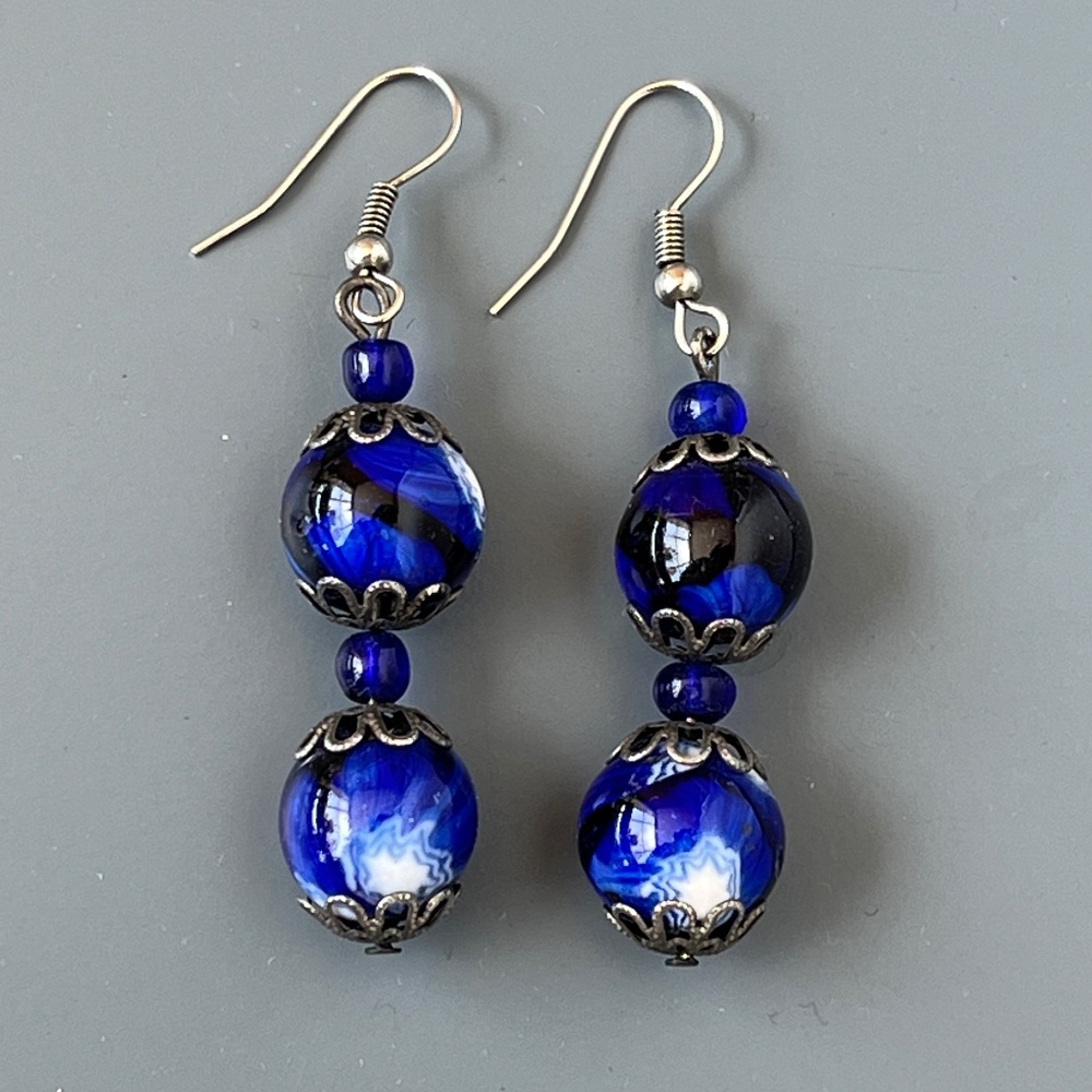 Hand made artisnal earrings with blue glass beads.